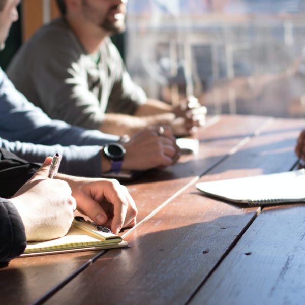 business people hands on desk as they collaborate together