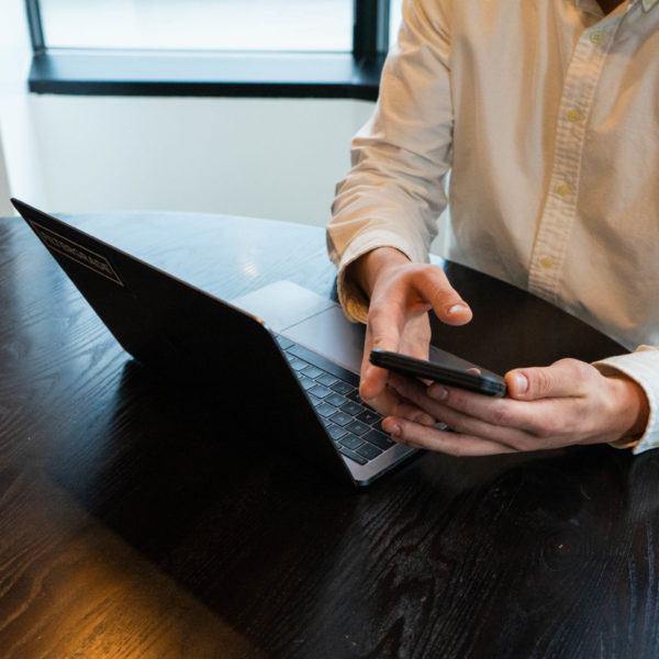 Business person working remotely on laptop and phone