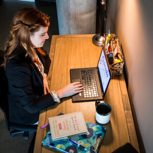 Anna-Vija McClain working on laptop in professional office
