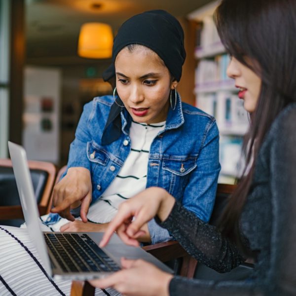 Remote workers collaborating on a laptop