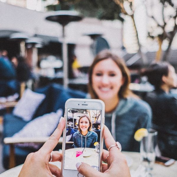 Woman getting her photo taken to post on social media