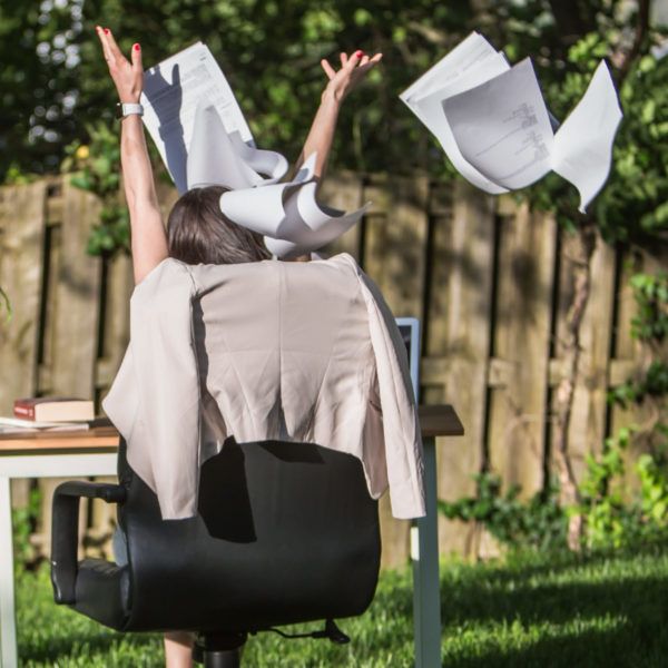 Woman excited throwing papers up in the air