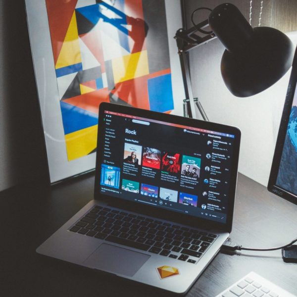 Laptop on desk with Spotify pulled up