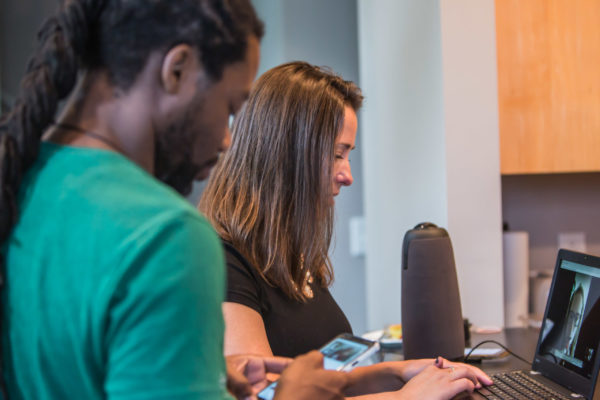 Two people evaluating a website on a laptop