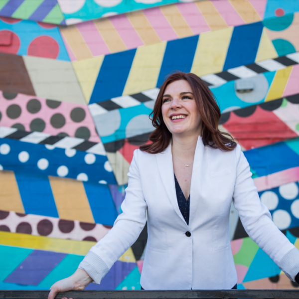 Anna-Vija CEO of Piccolo Solutions in front of a mural in Nashville